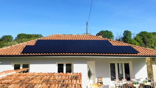 Panneaux solaires sur le toit d'une maison avec un ciel bleu en arrière-plan. Énergie renouvelable.